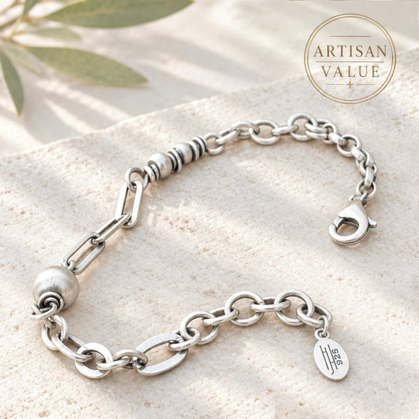 Handmade sterling silver bracelet featuring mixed oval and round chain links and decorative silver beads.